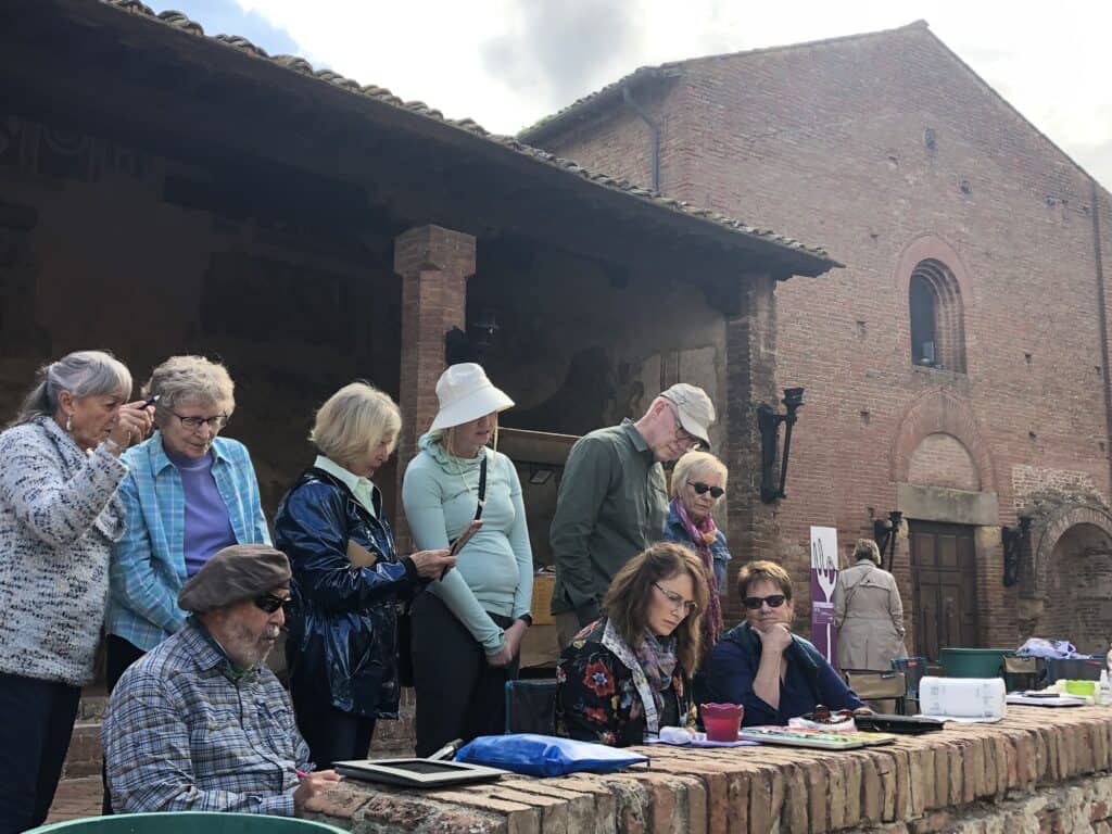 Group of artists painting outdoors together, fostering a collaborative learning environment to enhance artistic growth and development through the shared experience of painting outdoors with a group